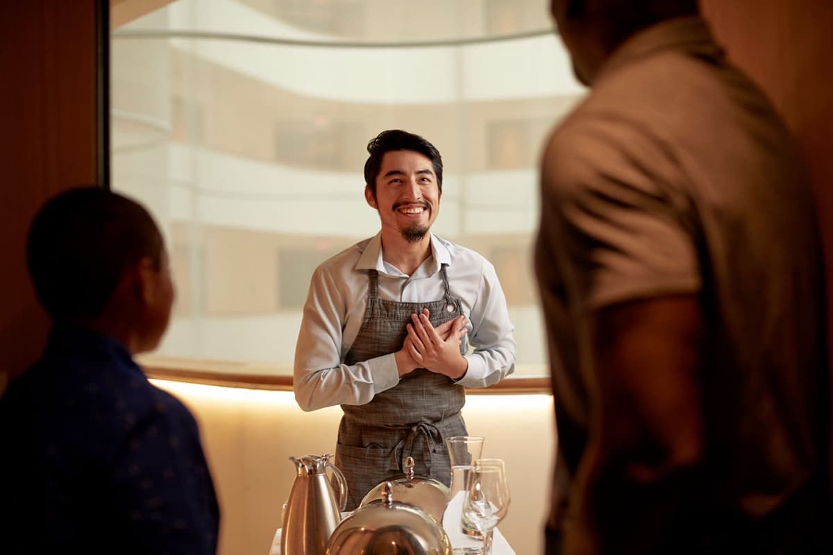 Hilton Food and Beverage Team Member with Guests